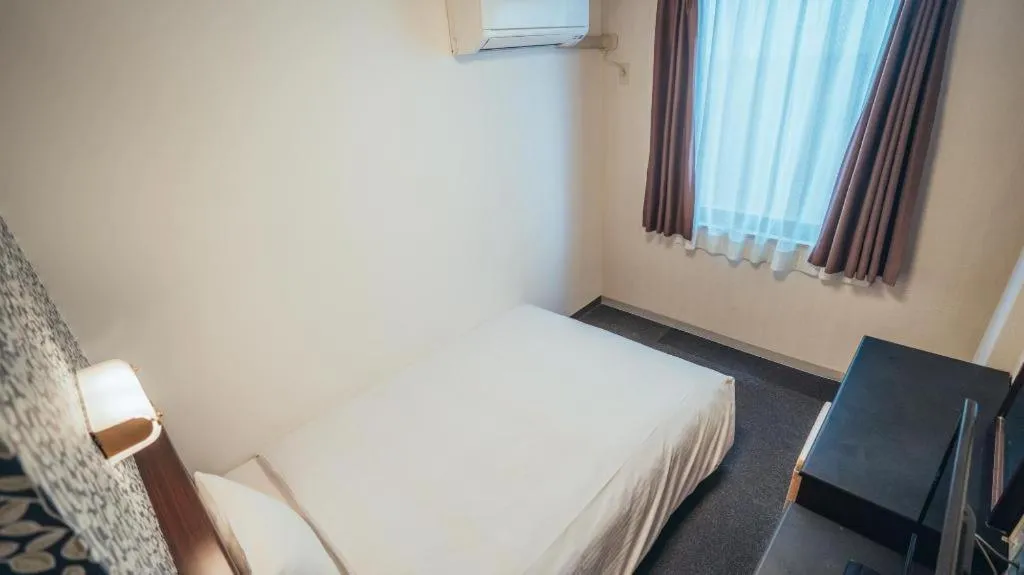 Bed in Hotel AreaOne Miyazaki City