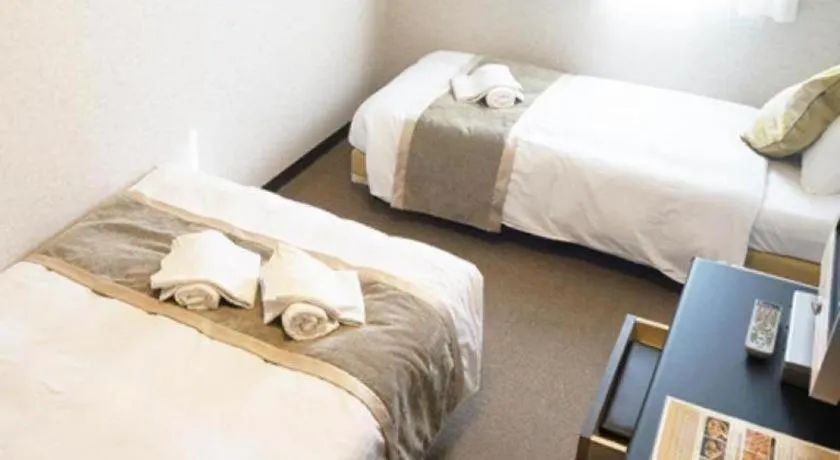 Bed in Hotel AreaOne Miyazaki City