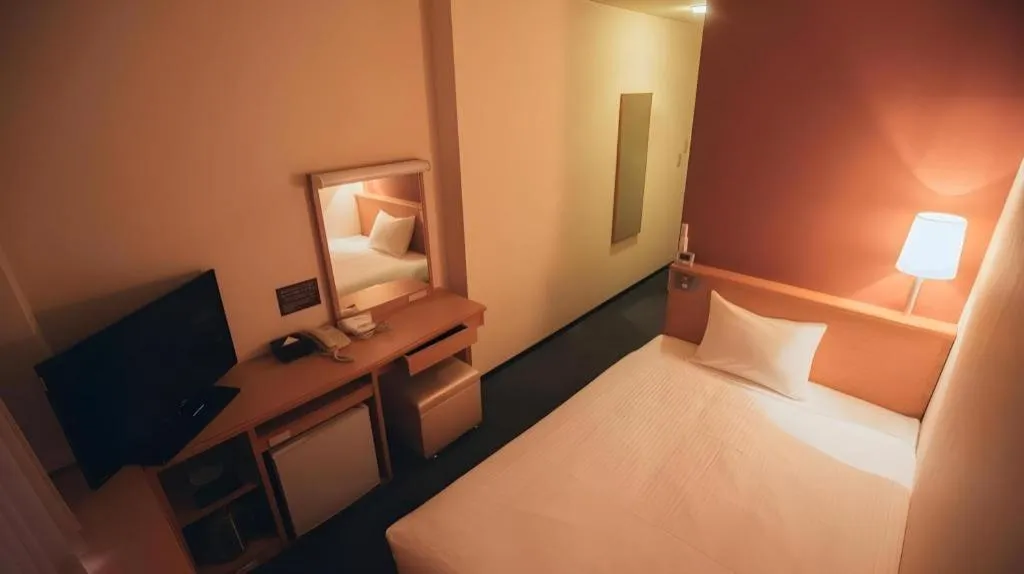 Bed in Hotel AreaOne Miyazaki City