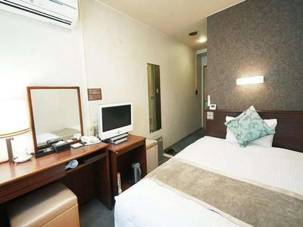 Bed in Hotel AreaOne Miyazaki City