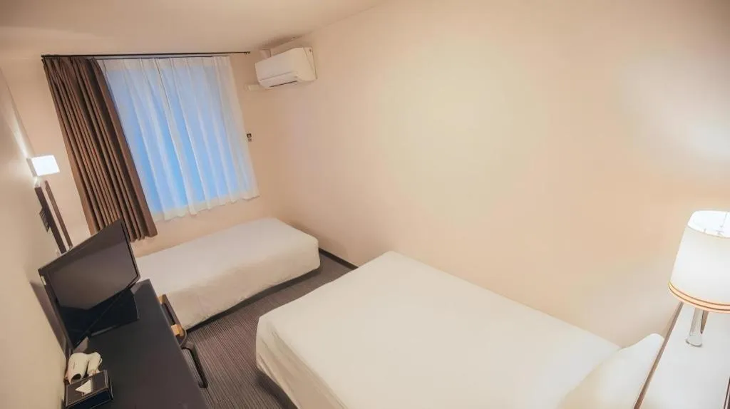 Bed in Hotel AreaOne Miyazaki City