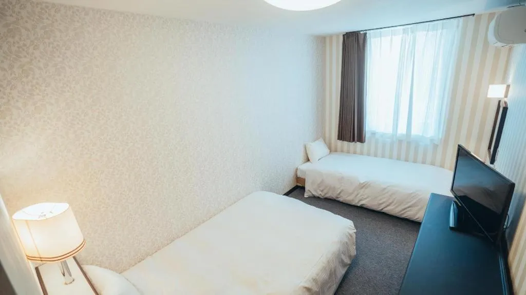 Bed in Hotel AreaOne Miyazaki City