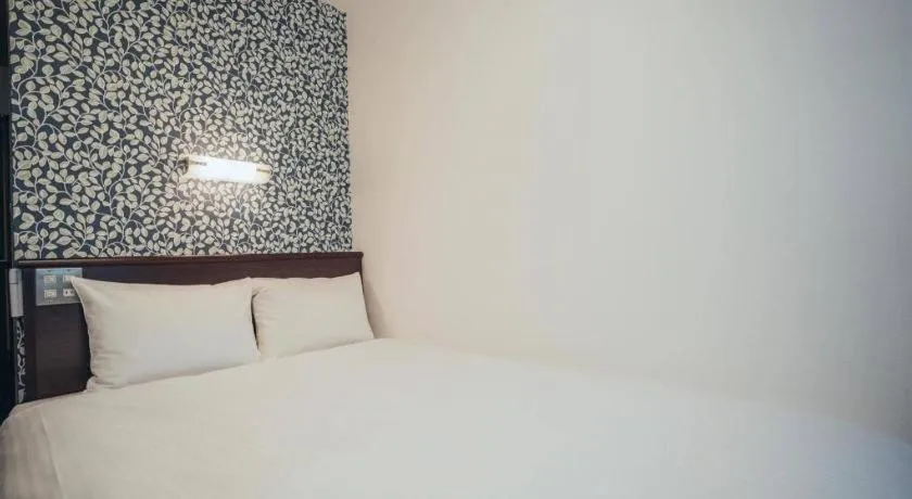 Bed in Hotel AreaOne Miyazaki City