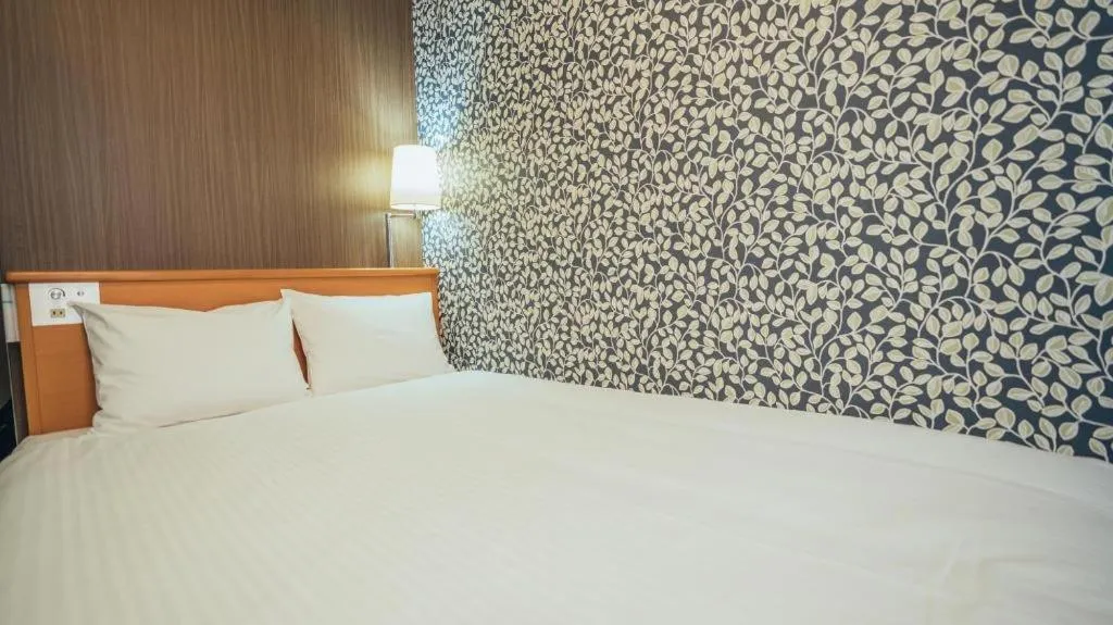 Bed in Hotel AreaOne Miyazaki City
