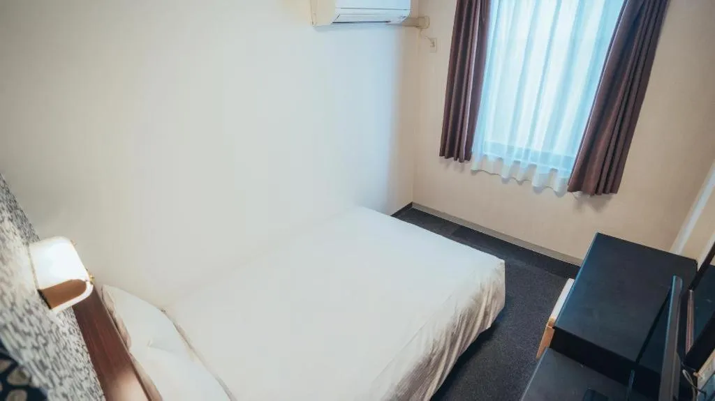 Bed in Hotel AreaOne Miyazaki City