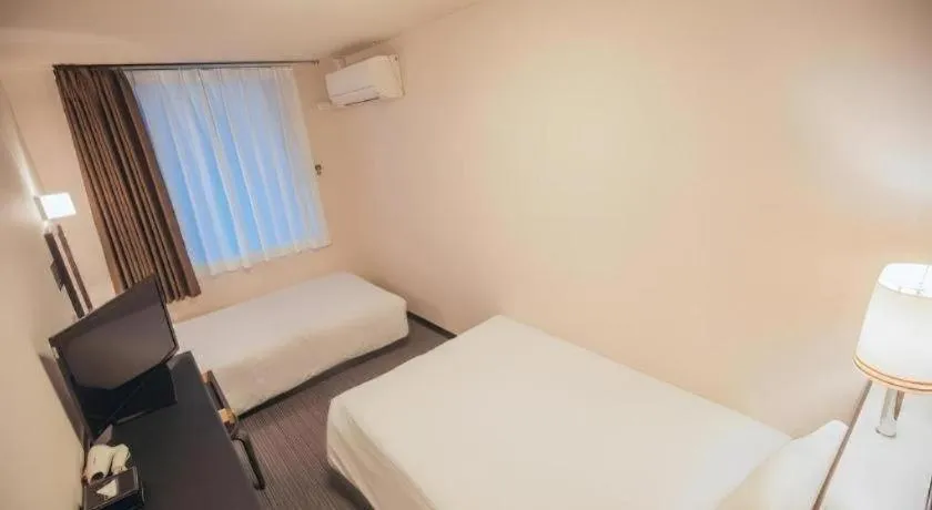 Bed in Hotel AreaOne Miyazaki City