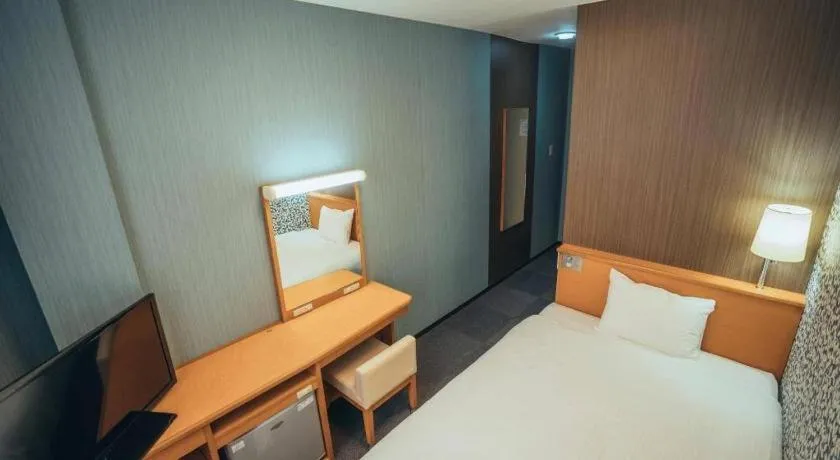 Bed in Hotel AreaOne Miyazaki City