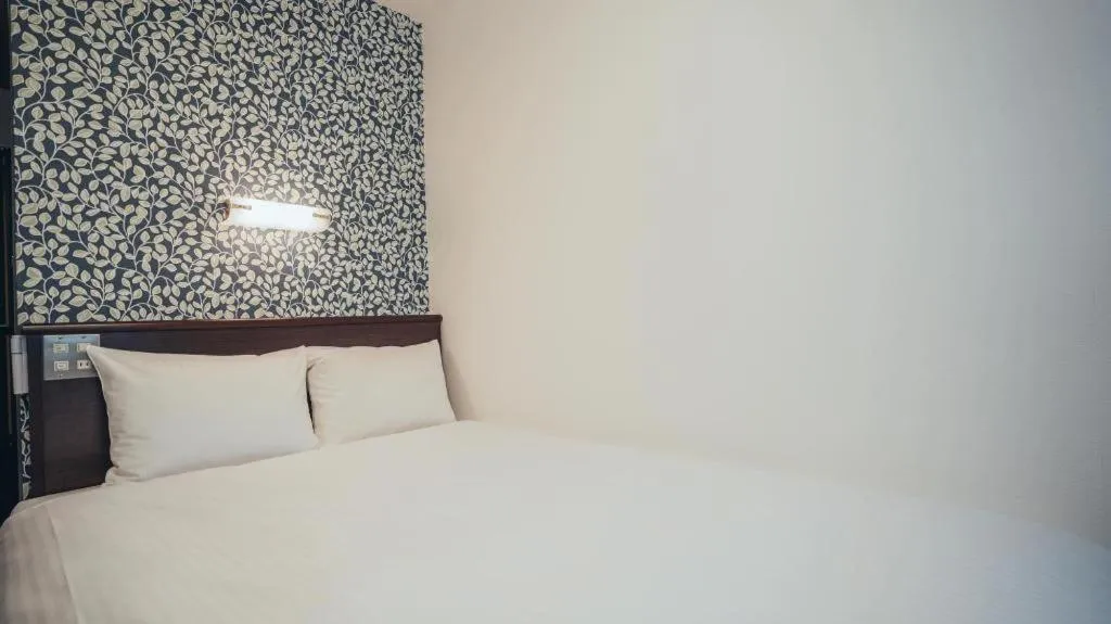 Bed in Hotel AreaOne Miyazaki City