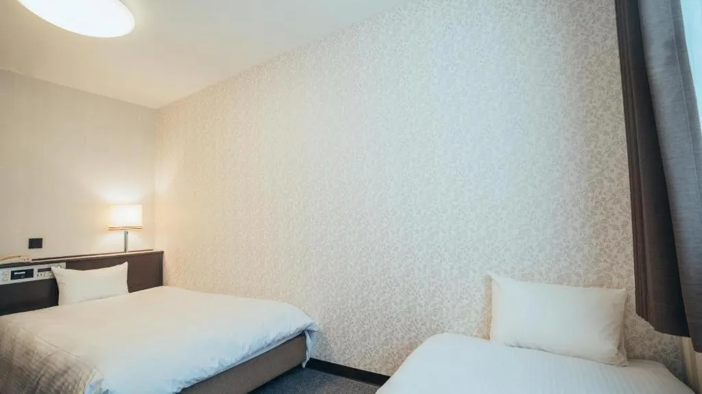 Bed in Hotel AreaOne Miyazaki City