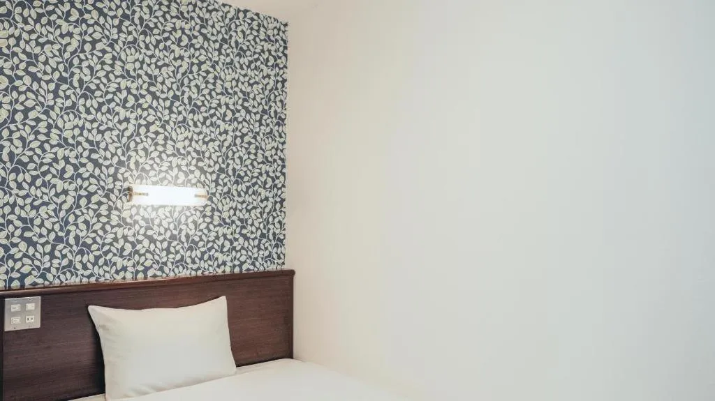 Bed in Hotel AreaOne Miyazaki City