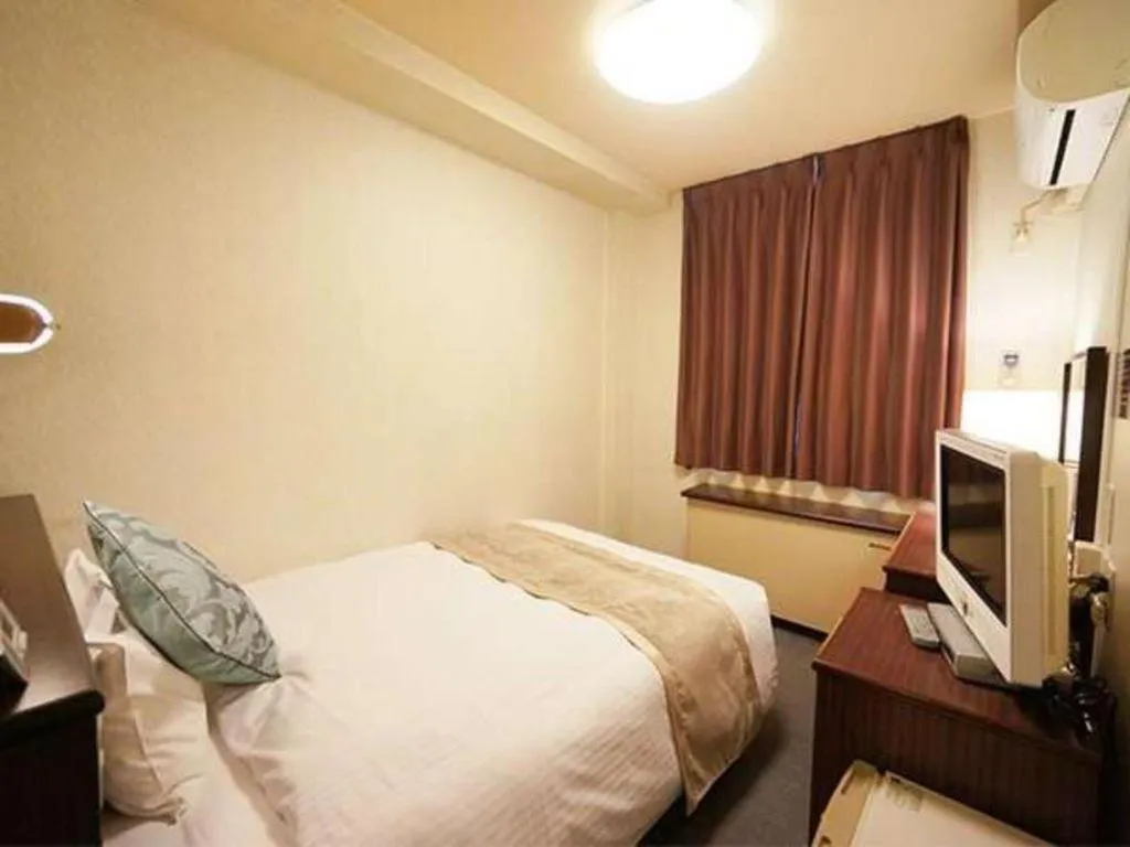 Bed in Hotel AreaOne Miyazaki City