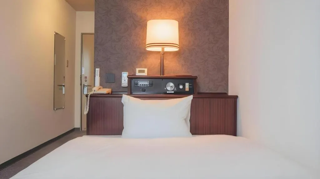 Bed in Hotel AreaOne Miyazaki City