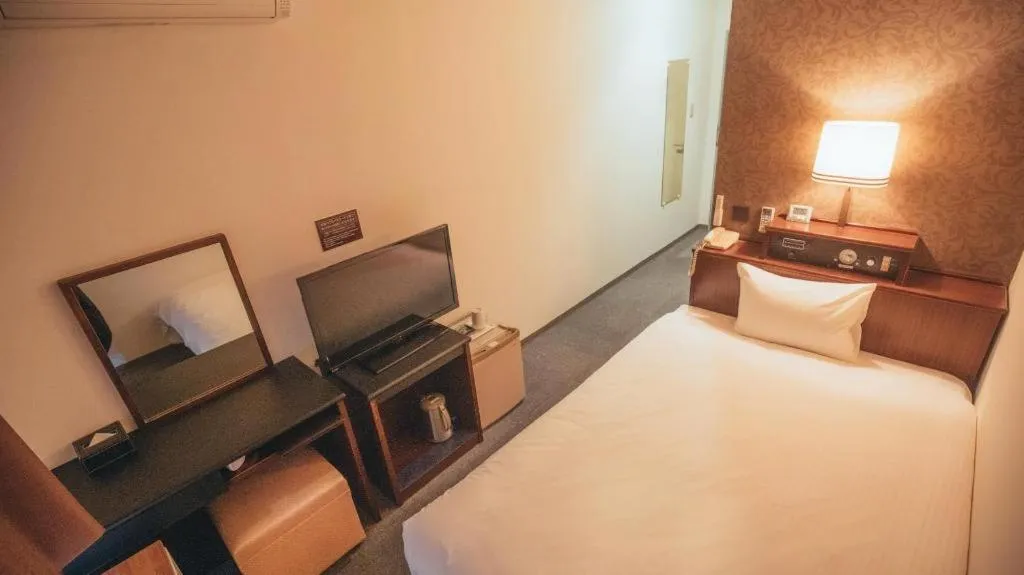 Bed in Hotel AreaOne Miyazaki City