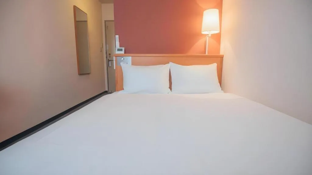 Bed in Hotel AreaOne Miyazaki City