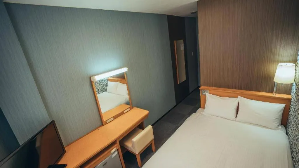 Bed in Hotel AreaOne Miyazaki City
