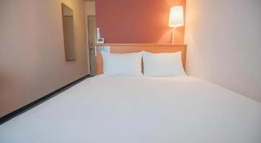 Bed in Hotel AreaOne Miyazaki City
