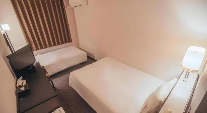 Bed in Hotel AreaOne Miyazaki City