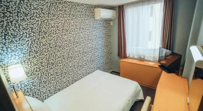 Bed in Hotel AreaOne Miyazaki City