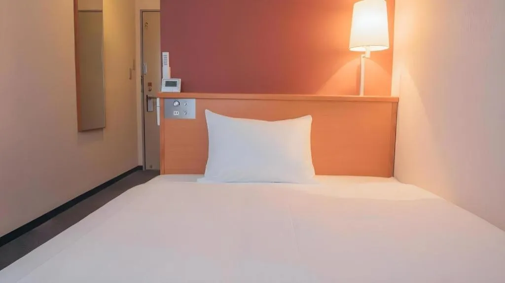 Bed in Hotel AreaOne Miyazaki City