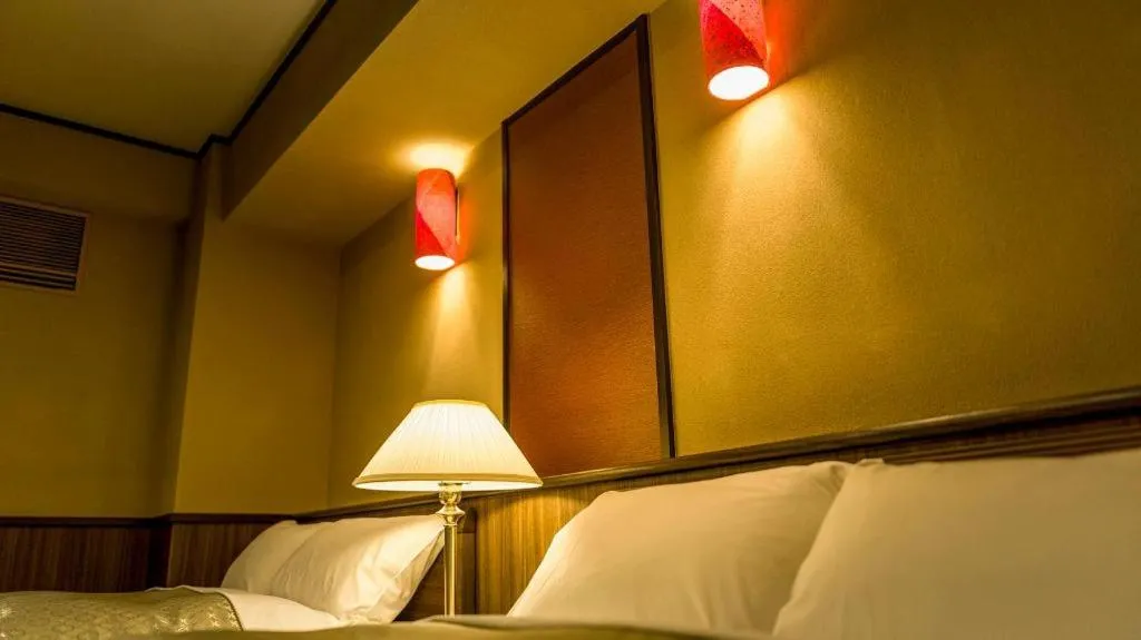 Bed in Shinojima Royal Hotel Kasuisou