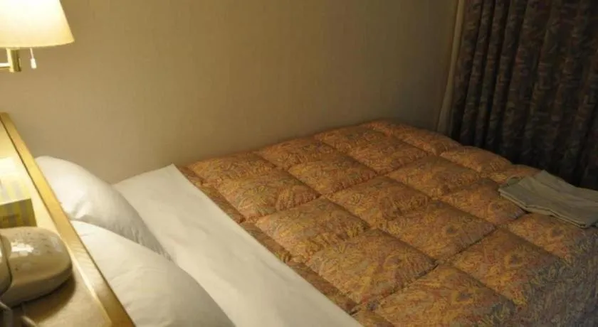 Bed in Palace Inn Toyota