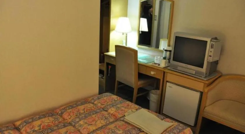 Bed in Palace Inn Toyota