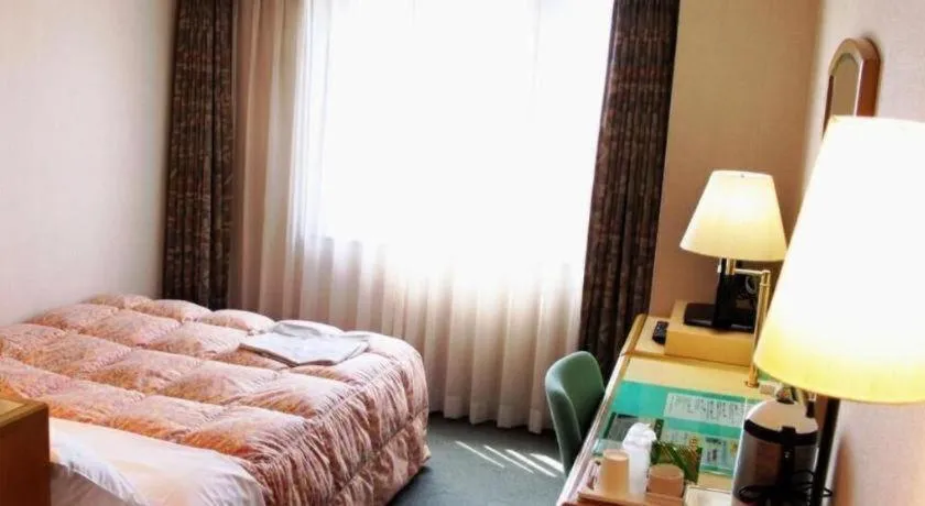 Bed in Palace Inn Toyota