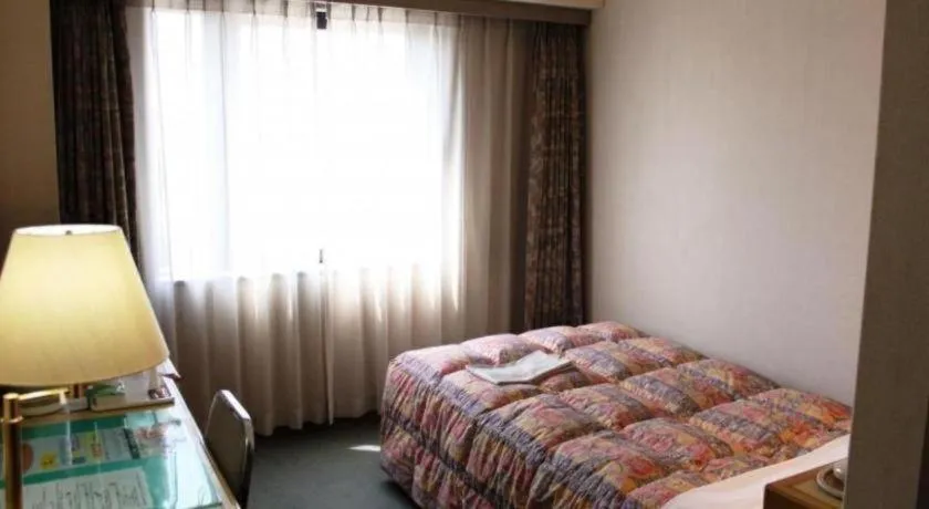 Bed in Palace Inn Toyota