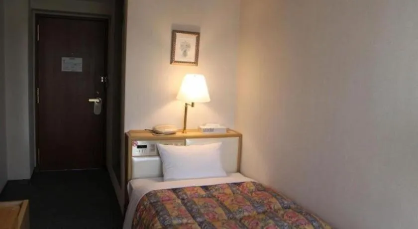 Bed in Palace Inn Toyota