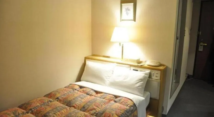 Bed in Palace Inn Toyota