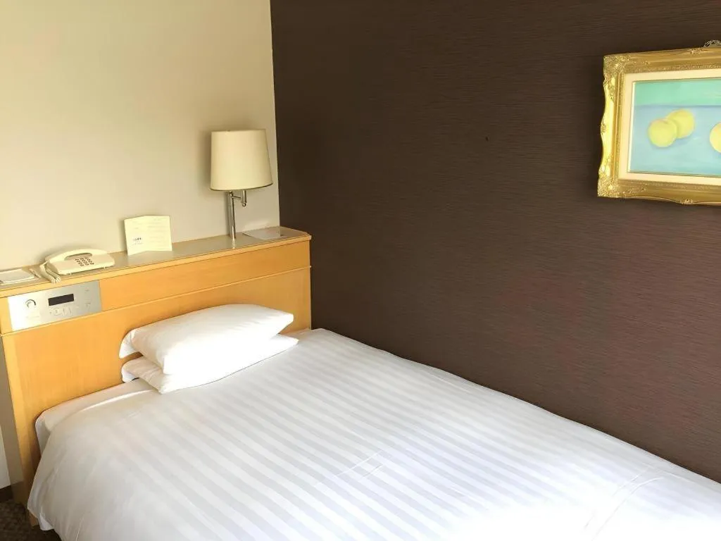 Bed in Green Hill Hotel Onomichi