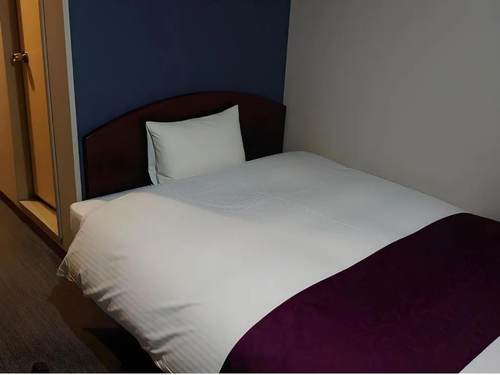 Bed in AKISAWA HOTEL