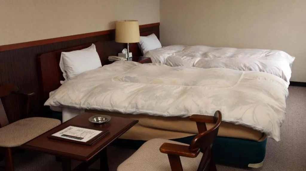 Bed in AKISAWA HOTEL