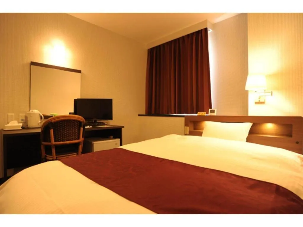 Bed in AKISAWA HOTEL