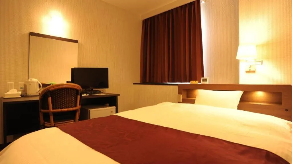 Bed in AKISAWA HOTEL