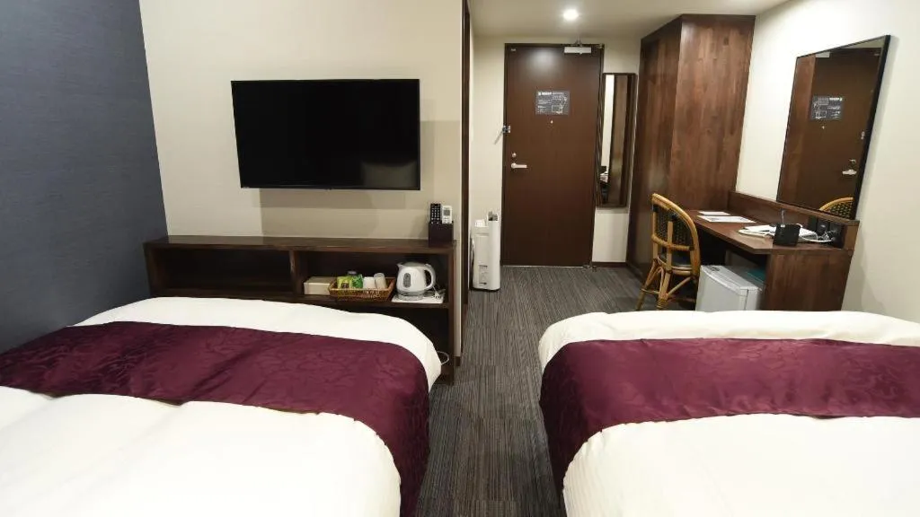 Bed in AKISAWA HOTEL