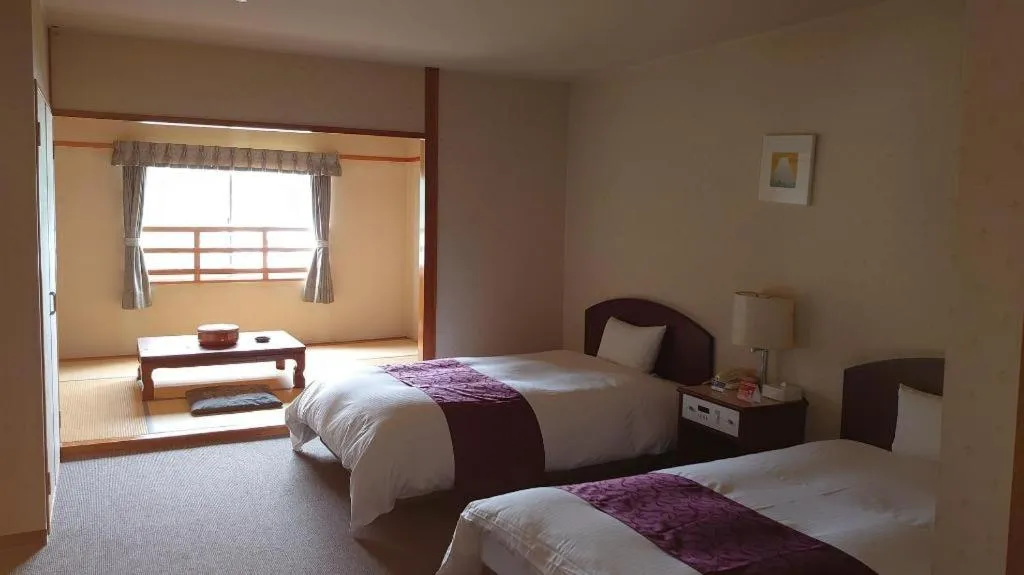 Bed in AKISAWA HOTEL
