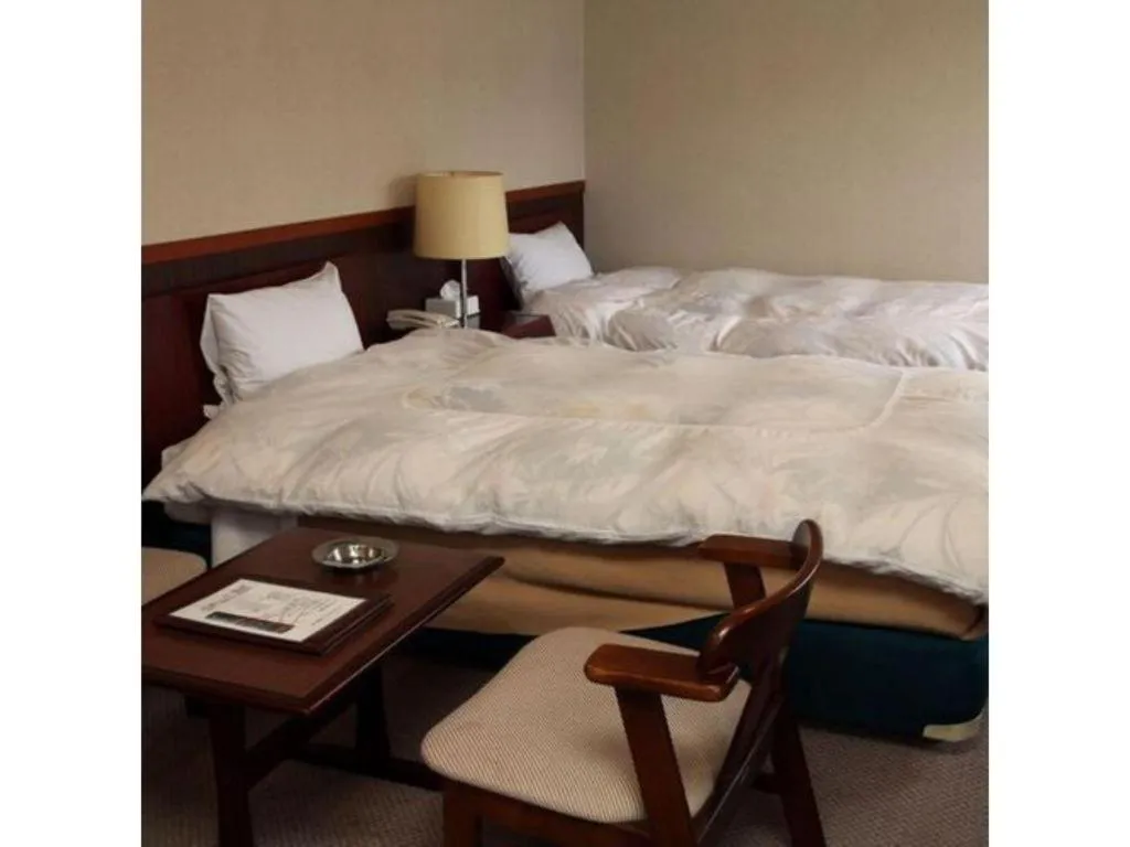 Bed in AKISAWA HOTEL