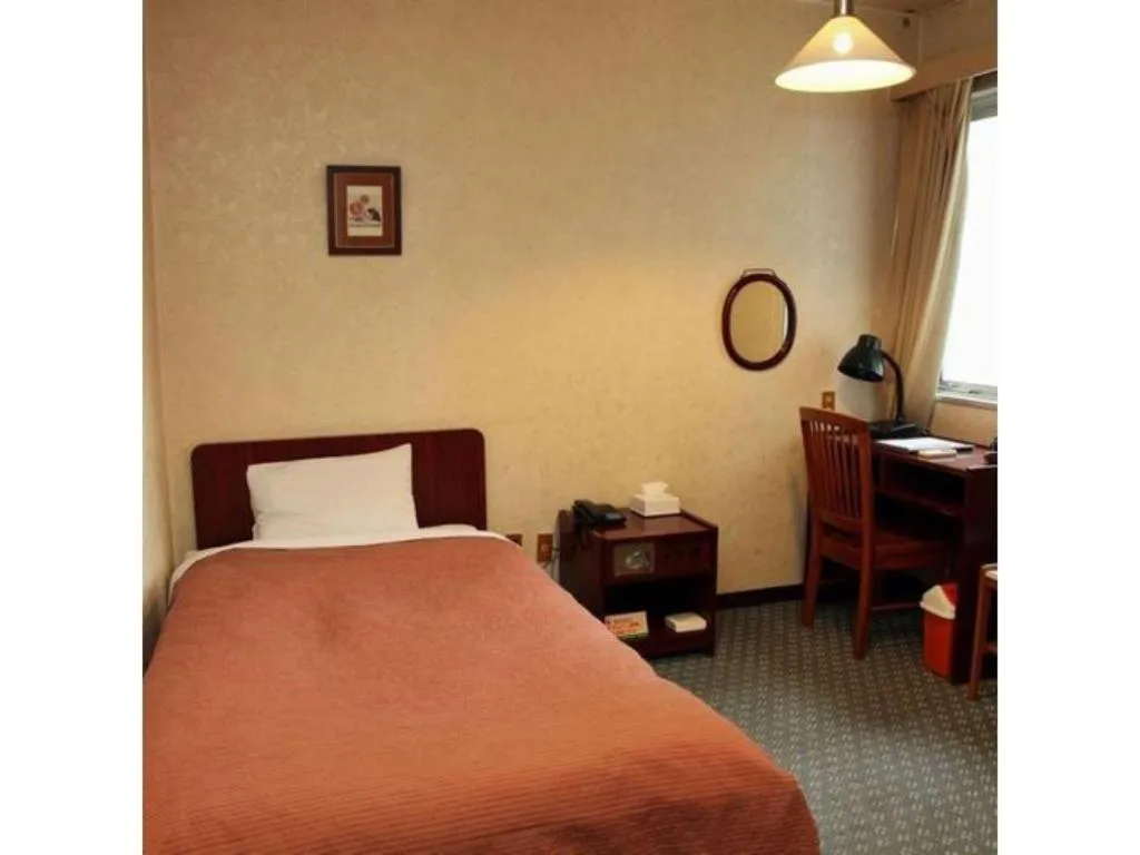 Bed in AKISAWA HOTEL