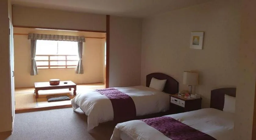 Bed in AKISAWA HOTEL