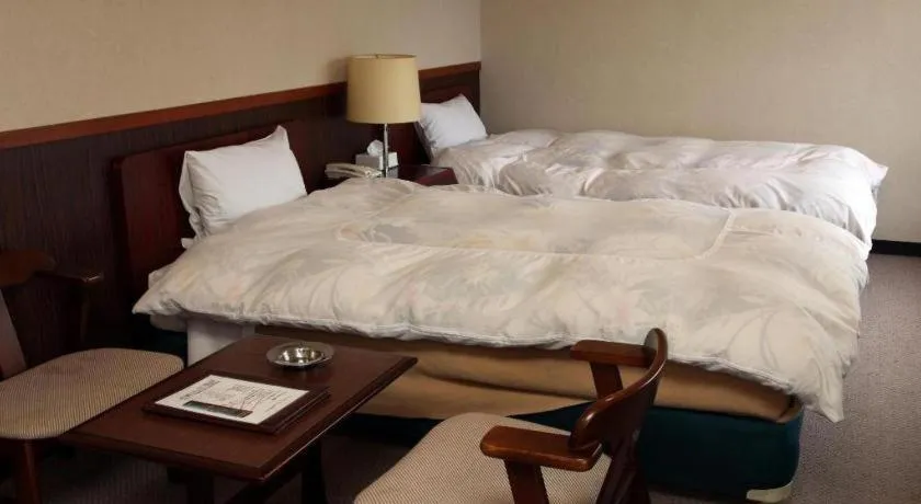 Bed in AKISAWA HOTEL