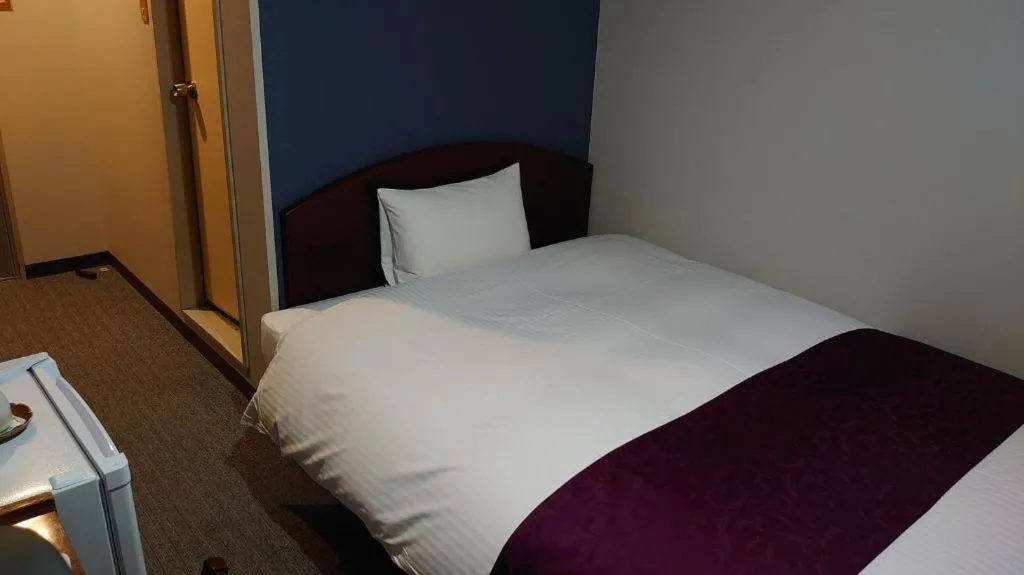 Bed in AKISAWA HOTEL