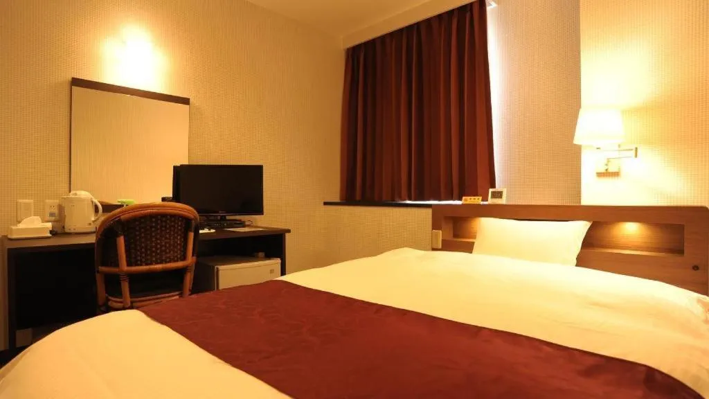 Bed in AKISAWA HOTEL