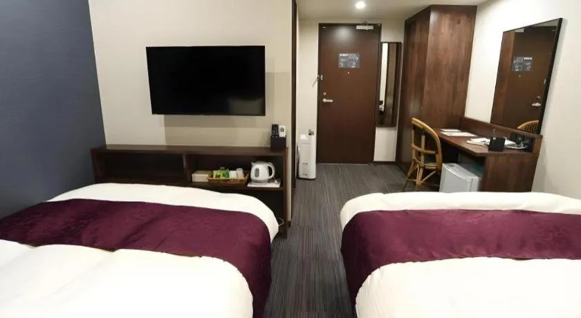 Bed in AKISAWA HOTEL