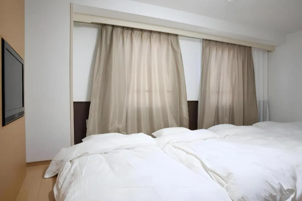 Bed in Hotel Sunshine Iwaki