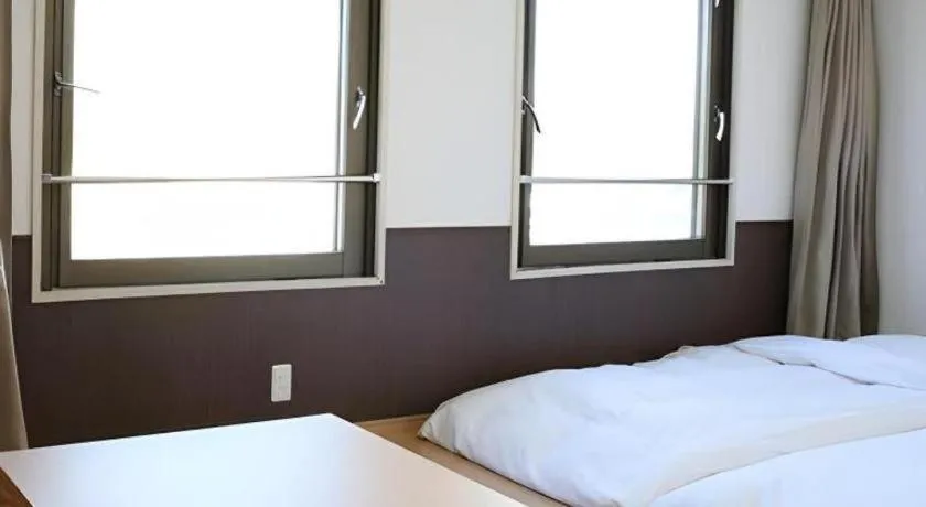 Bed in Hotel Sunshine Iwaki