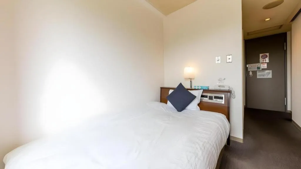 Bed in Tabist Yabuki Station Hotel