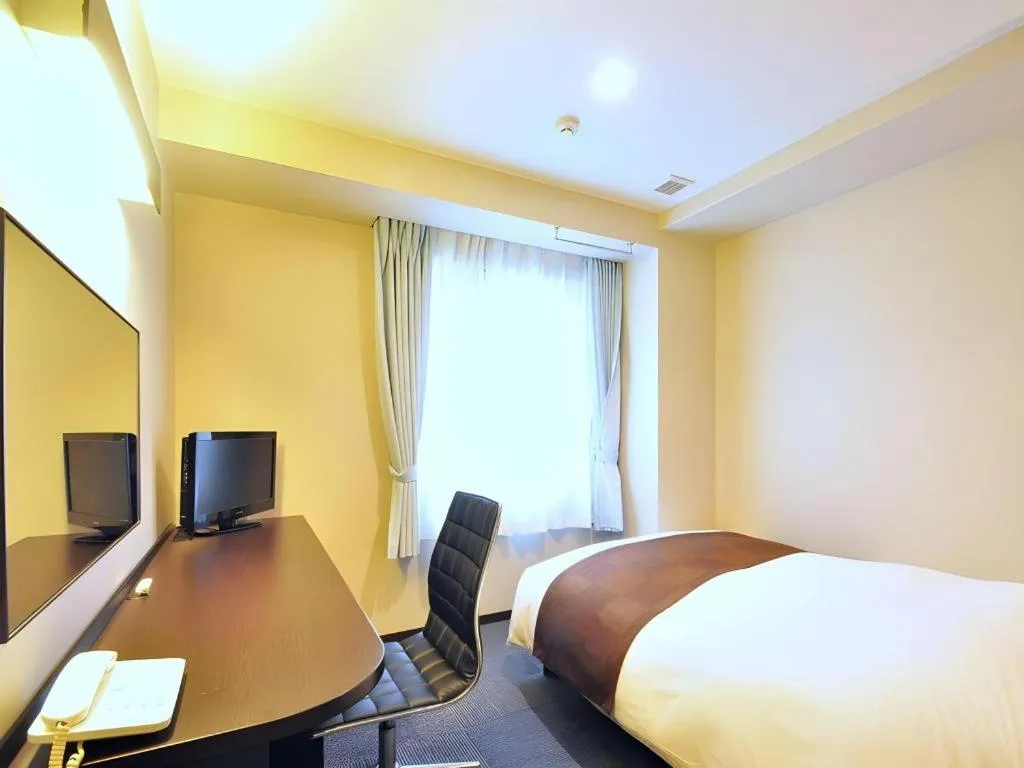 Bed in Hotel New Amami