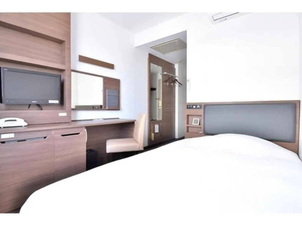 Bed in Hotel New Amami