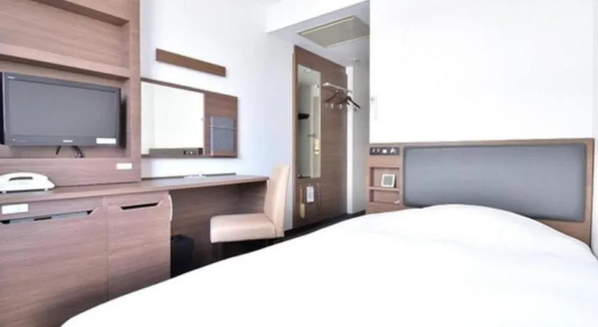 Bed in Hotel New Amami